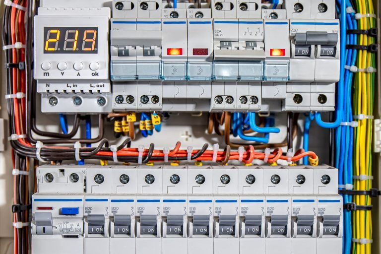 Switchboard equipment. Shield for enterprise electrification. Switchboard for control over electrical equipment. Labeled panel with wires and switches at enterprise.