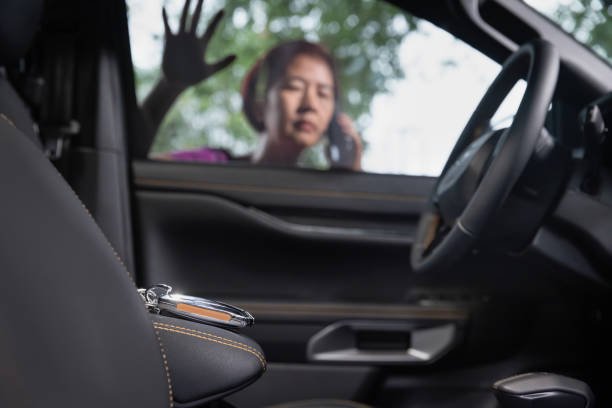 A woman sitting in the driver's seat of a car, representing automotive locksmith services near Oil City for car keys.