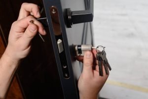 A person unlocking a door with keys, symbolizing Locksmith Near Bossier Parish, LA