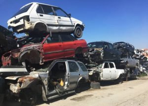 . A heap of cars stacked on each other at Reliable Auto Junkyard, Miami, highlighting automotive recycling.