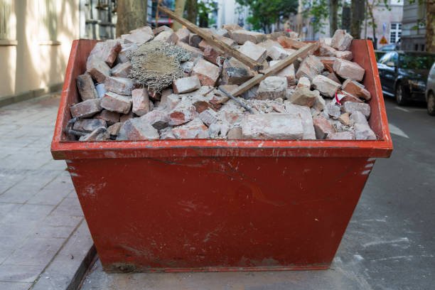 A dumpster brimming with rubble on a street, emphasizing the importance of removing construction debris.