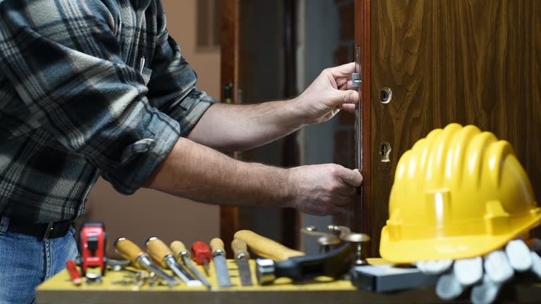 A man displays a key near a lock, illustrating the benefits of hiring a local locksmith in Dearborn, MI.