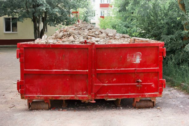 A red dumpster for rental placed outside a house, indicating waste disposal services.