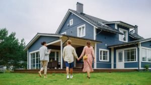 A family walks together in front of a house, promoting Home Loan Experts-3 Keys Lending services.