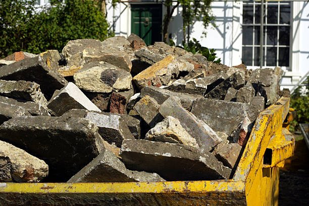 A street scene featuring a dumpster overflowing with rubble, highlighting the removal of construction debris.