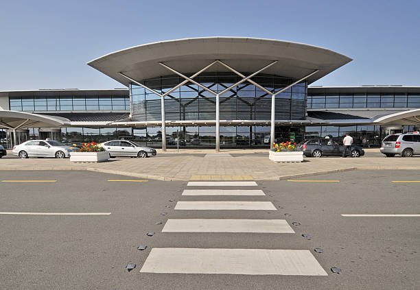 Vehicles traveling along the road, highlighting a private airport car service.