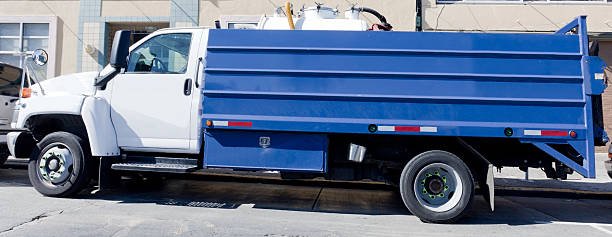 Parked blue and white sanitation truck.