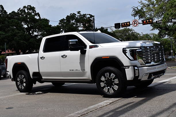 A trucks parked neatly in a parking lot under clear skies.