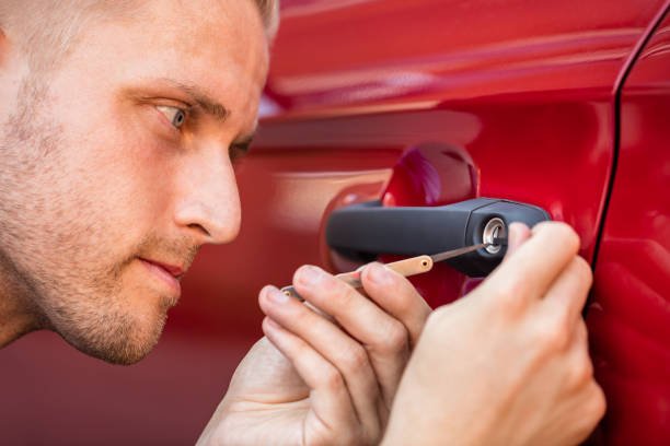 An individual is fixing a car door handle, showcasing expertise in automotive locksmithing in Lincoln Park, MI.