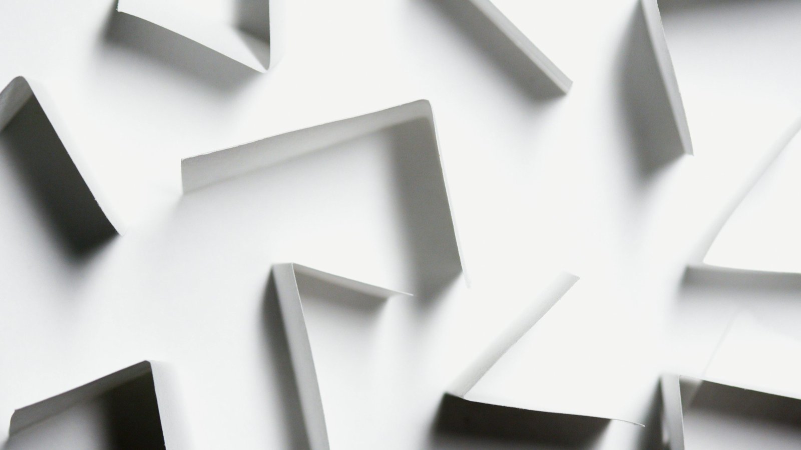 Abstract white paper shapes creating a modern geometric design with shadows.