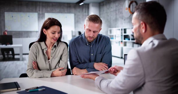 A person shaking hands with another over a desk, symbolizing a mortgage agreement near Rock Hill.