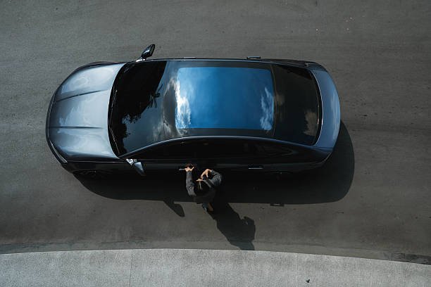 Overhead view of a car against a blue sky, representing a car service setting.