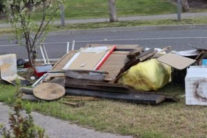 A disorganized collection of trash on the side of the road, emphasizing junk pick-up services in Sylvan Park, TN.