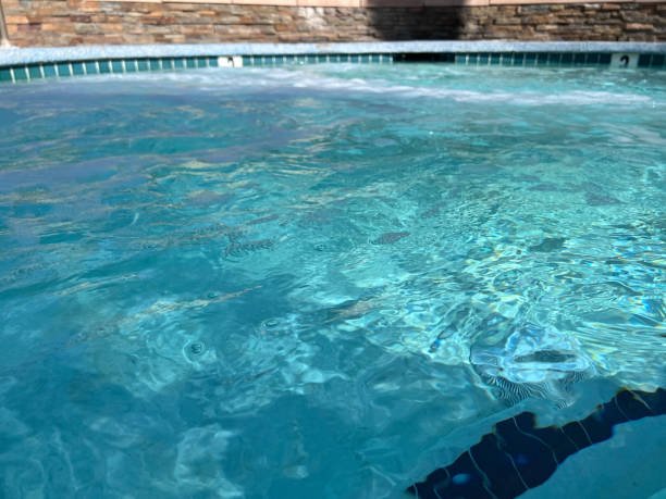 A pool with water and a wall nearby, serving as a visual for pool water leak detection scenarios.