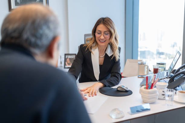 A man and woman engaged in a handshake at a meeting, highlighting trust in mortgage services.