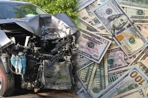 A car with a damaged front and a stack of money, depicting a cash-for-junk-cars service available in Winchester, OH.