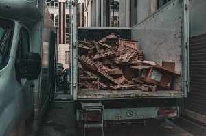A parked truck adjacent to a building, showcasing commercial junk removal services.