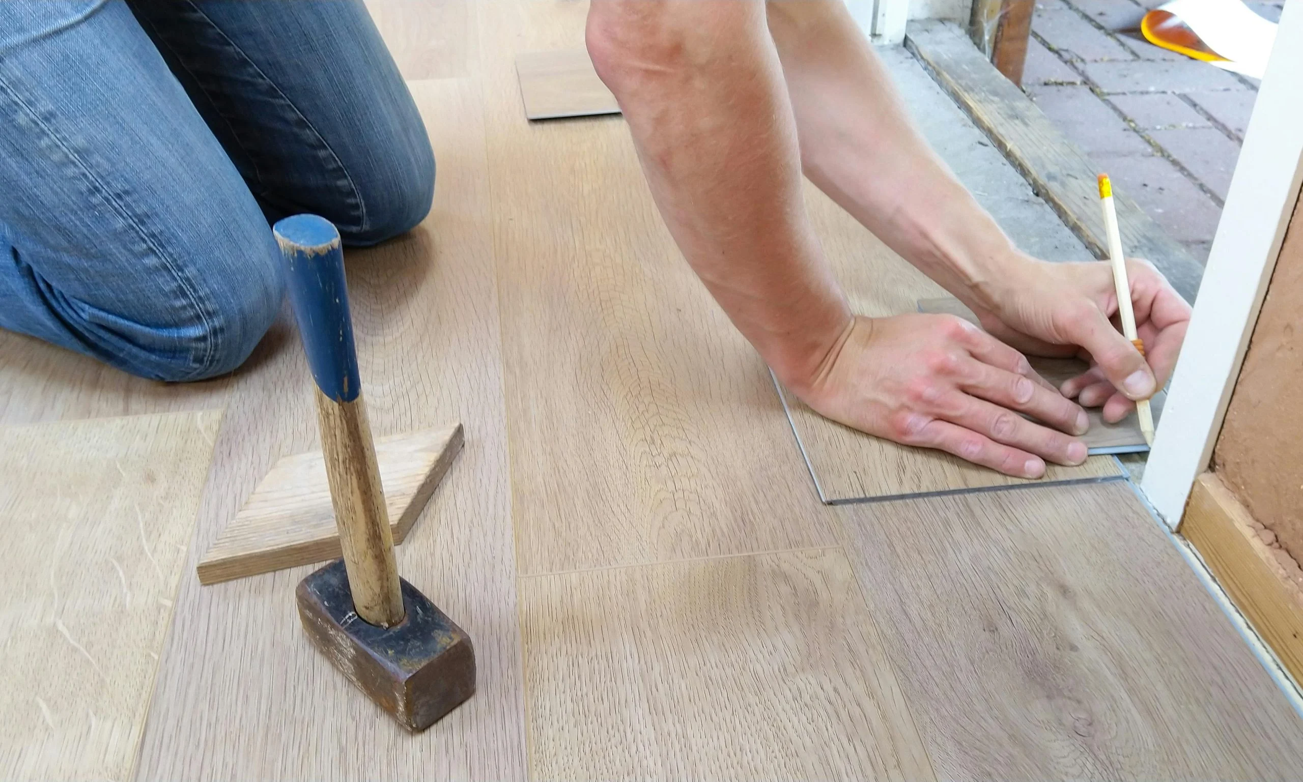 Worker installing hardwood flooring