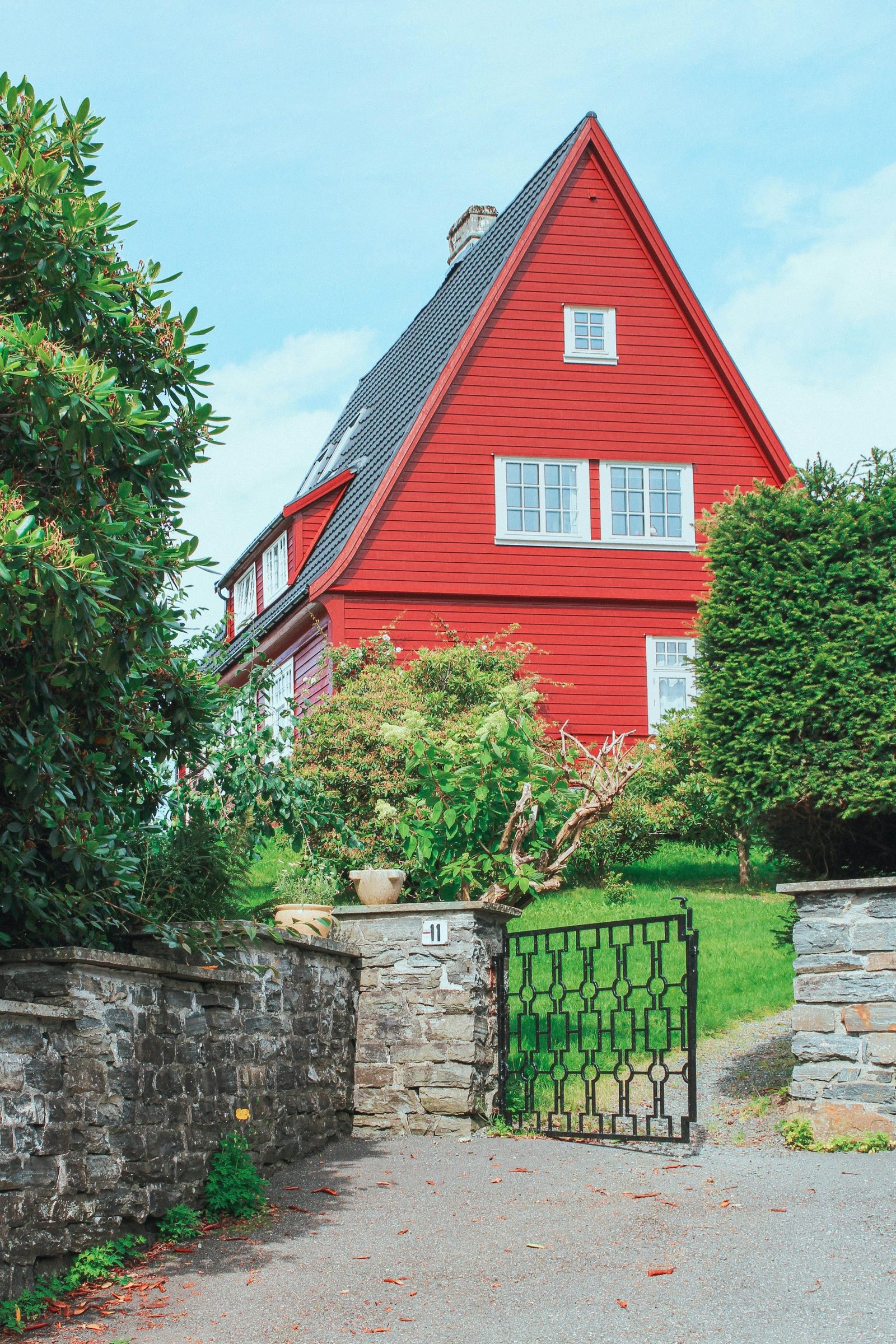 Charming red house with garden, traditional architecture, outdoors in Bergen, Norway.