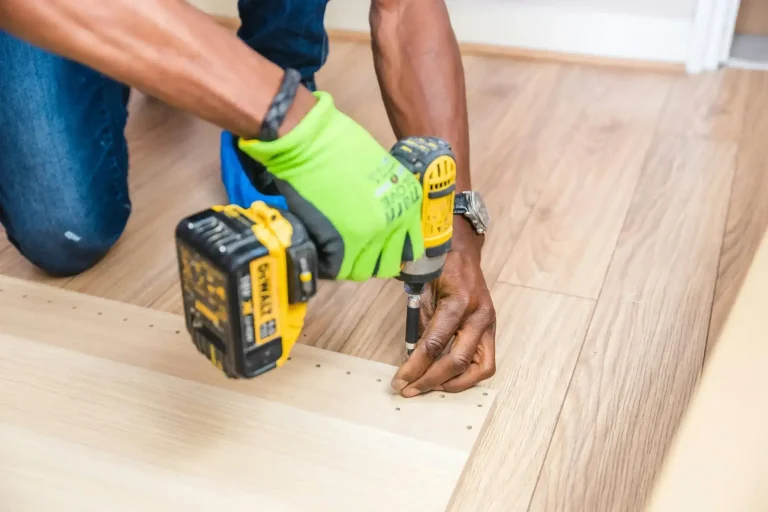 Worker installing hardwood flooring